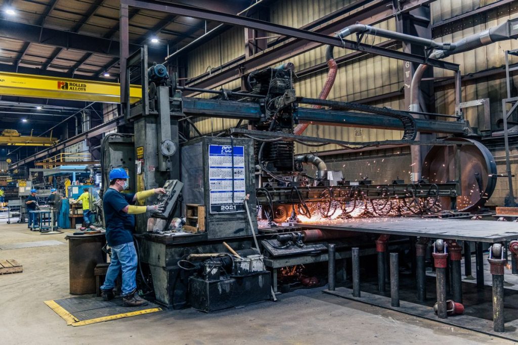 Operator running a machine in a metal workshop