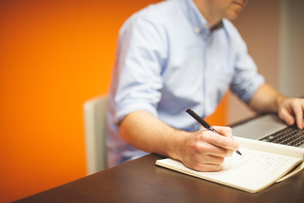Person working on a laptop in an office, managing advertising campaigns